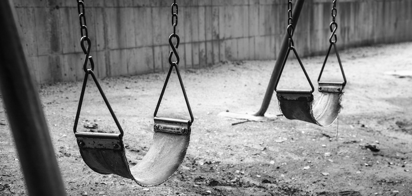empty swings in black and white
